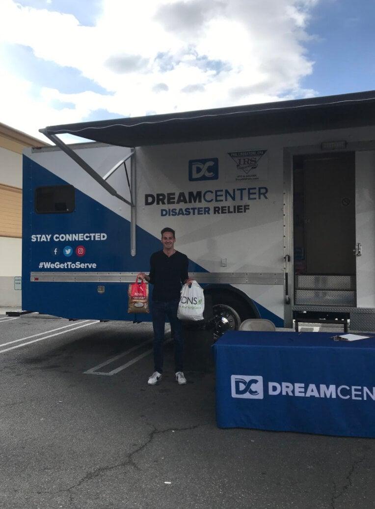 Mobile disaster relief trailer with Dream Center branding and setup in parking lot with table display