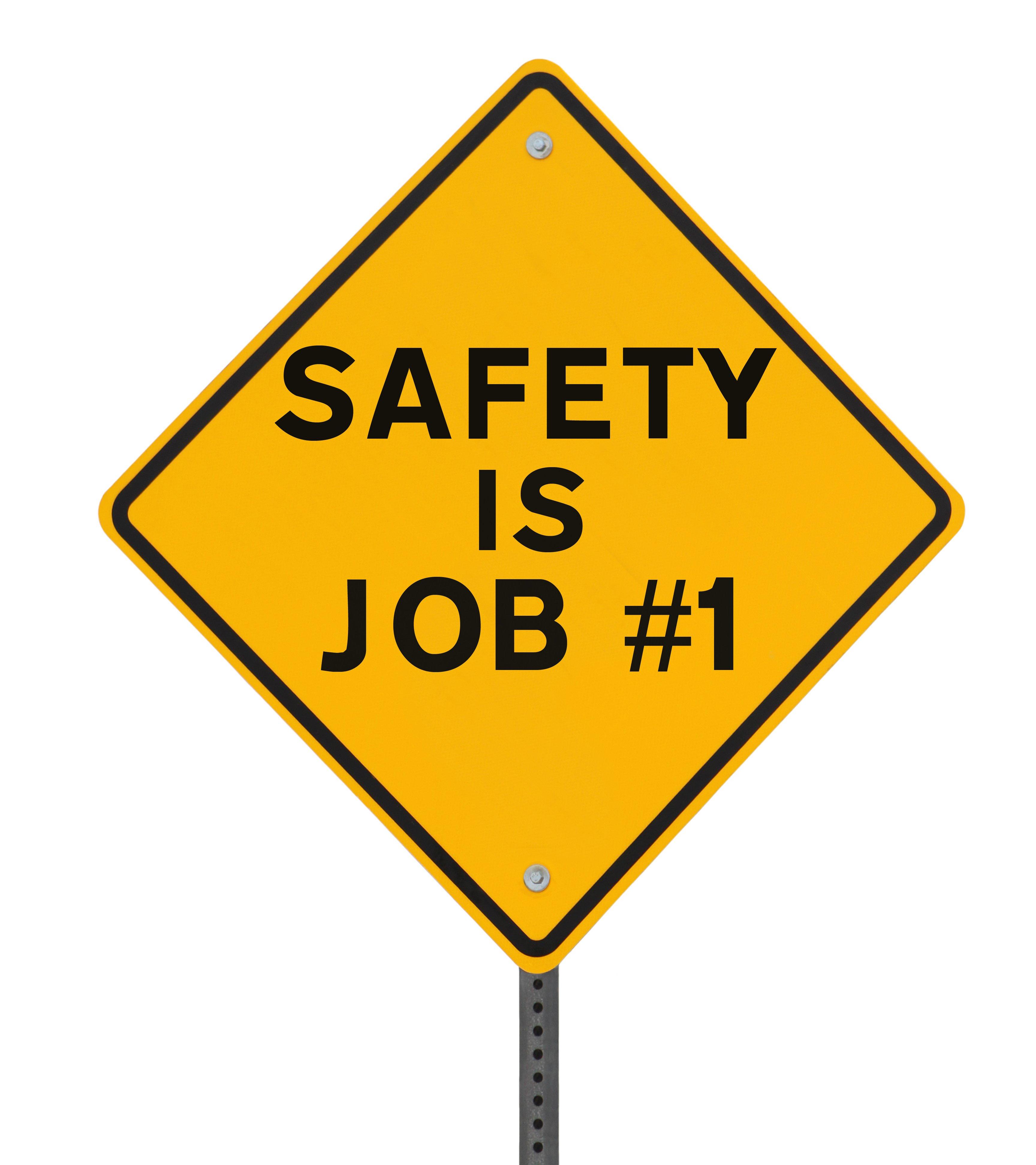 Yellow diamond-shaped safety sign with black text reading 'SAFETY IS JOB #1'