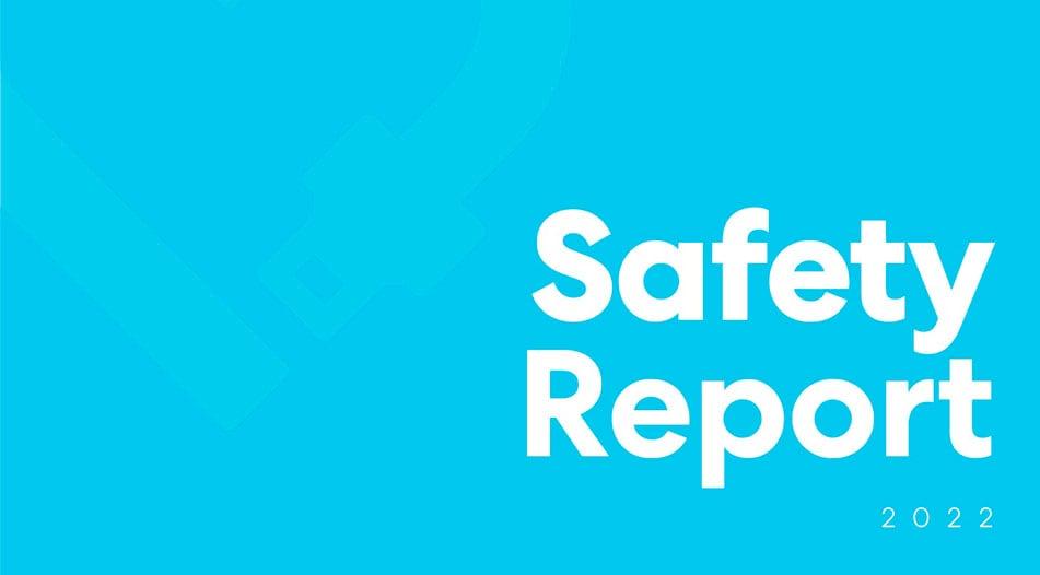 Safety Report 2022 text on light blue background with subtle key icon watermark
